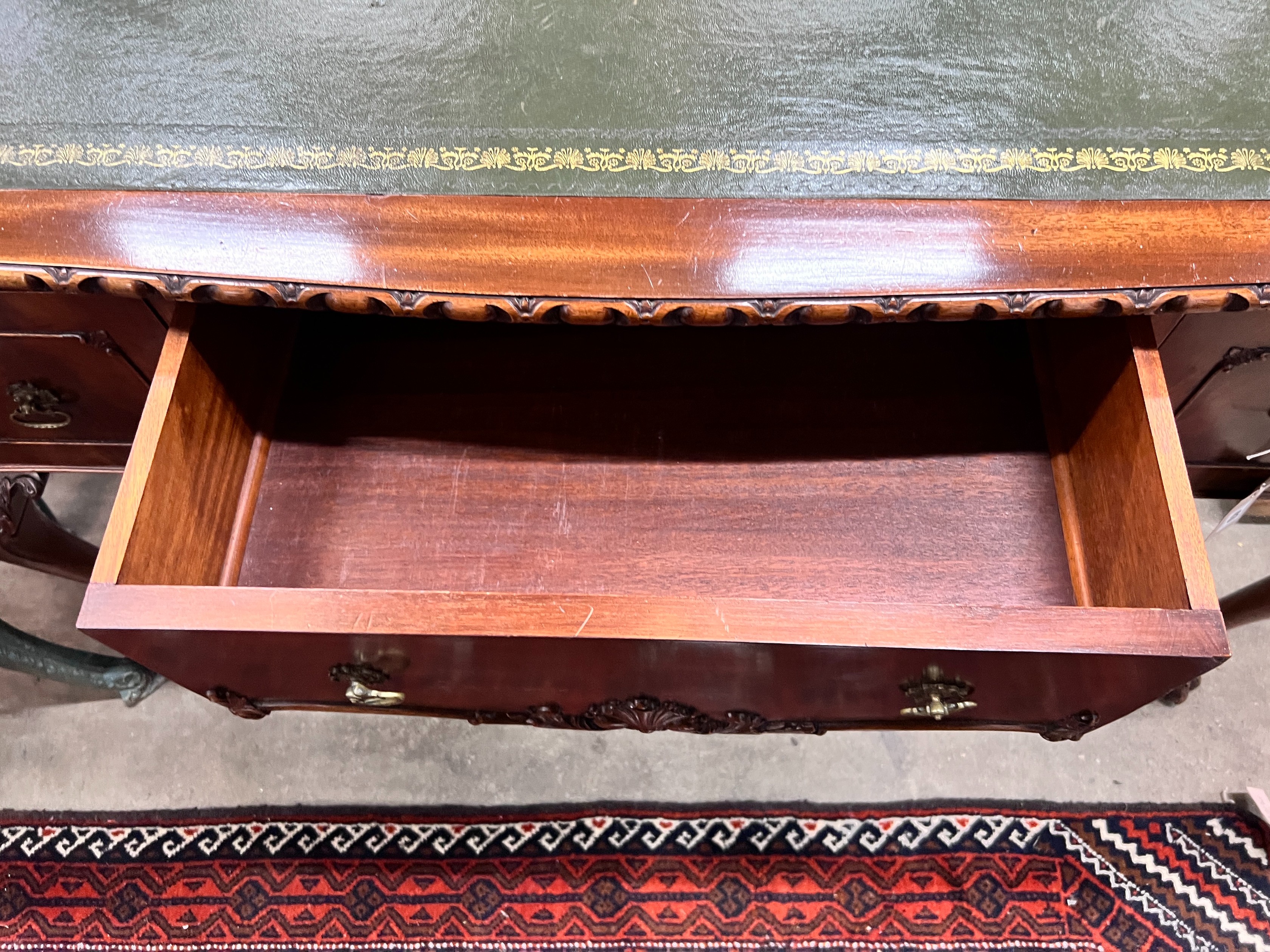 A reproduction George III style mahogany kneehole writing table, width 120cm, depth 58cm, height 76cm *Please note the sale commences at 9am.